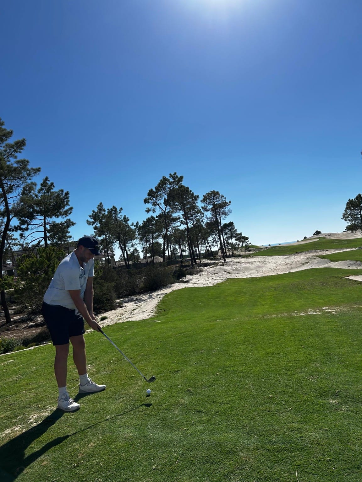 Jason addressing a ball on the fairway